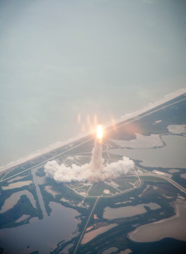 Space shuttle Atlantis is seen through the window of a Shuttle Training Aircraft (STA) as it launches from launch pad 39A at Kennedy Space Center on the STS-135 mission, Friday, July 8, 2011 in Cape Canaveral, Fla. Atlantis launched on the final flight of the shuttle program on a 12-day mission to the International Space Station. The STS-135 crew will deliver the Raffaello multipurpose logistics module containing supplies and spare parts for the space station. Photo Credit: (NASA/Dick Clark)